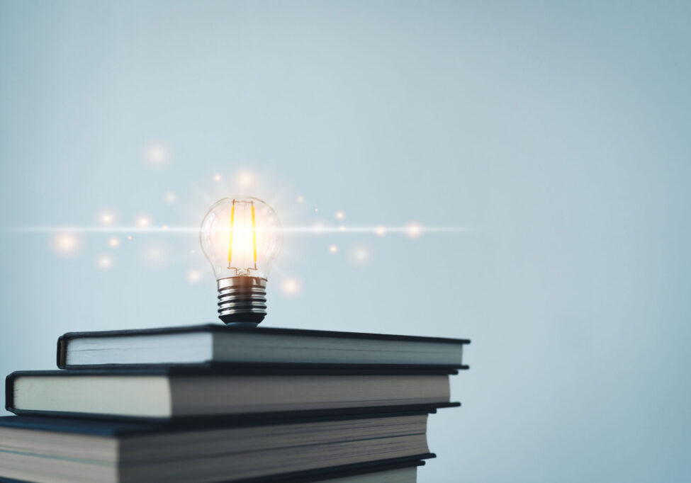 Glowing lightbulb or bright lamp with book or textbook. Skill improvement for student or businessperson. Studying and training course online at home. Business success idea, education learning concept